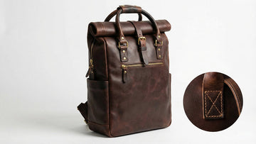 Well-worn genuine leather backpack showing rich brown patina, solid brass hardware, and reinforced stitching after years of daily use