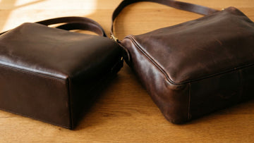 Two leather bags side by side showing a new stiff leather bag versus a broken-in leather bag with patina and softened shape