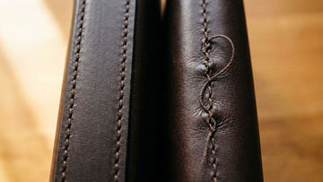 Close-up comparison of quality leather bag stitching with even dense thread versus poor stitching with uneven tension and puckering