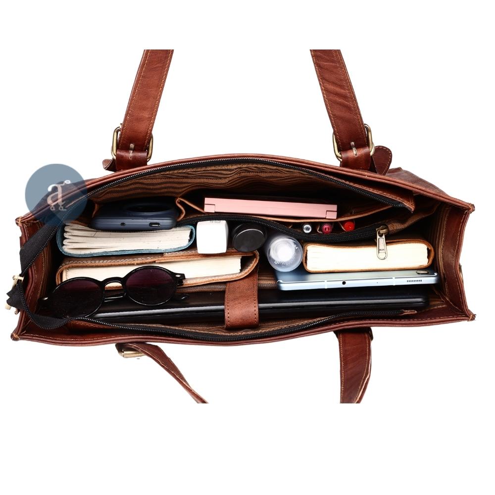 Top View of a Leather Laptop Tote Bag Packed with Essentials, Showing Organized Compartments and Zipper Pockets