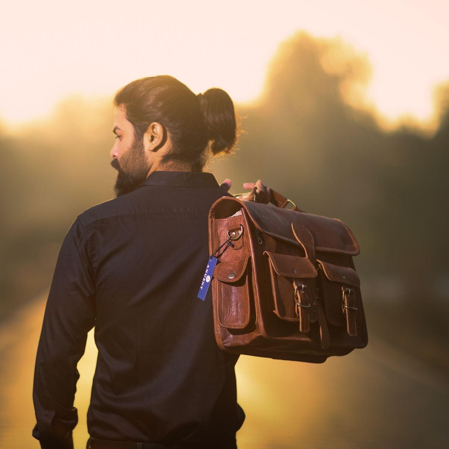 Man in Black Shirt Carrying The Strategist from Top Handle