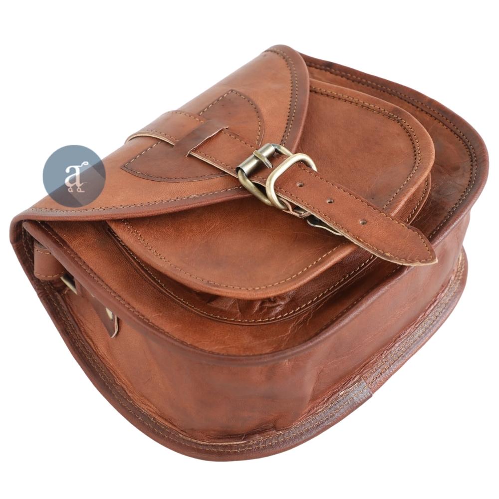 Top View of Brown Leather Saddle Purse with Buckle, Showcasing Detailed Stitching and Smooth Leather Finish.