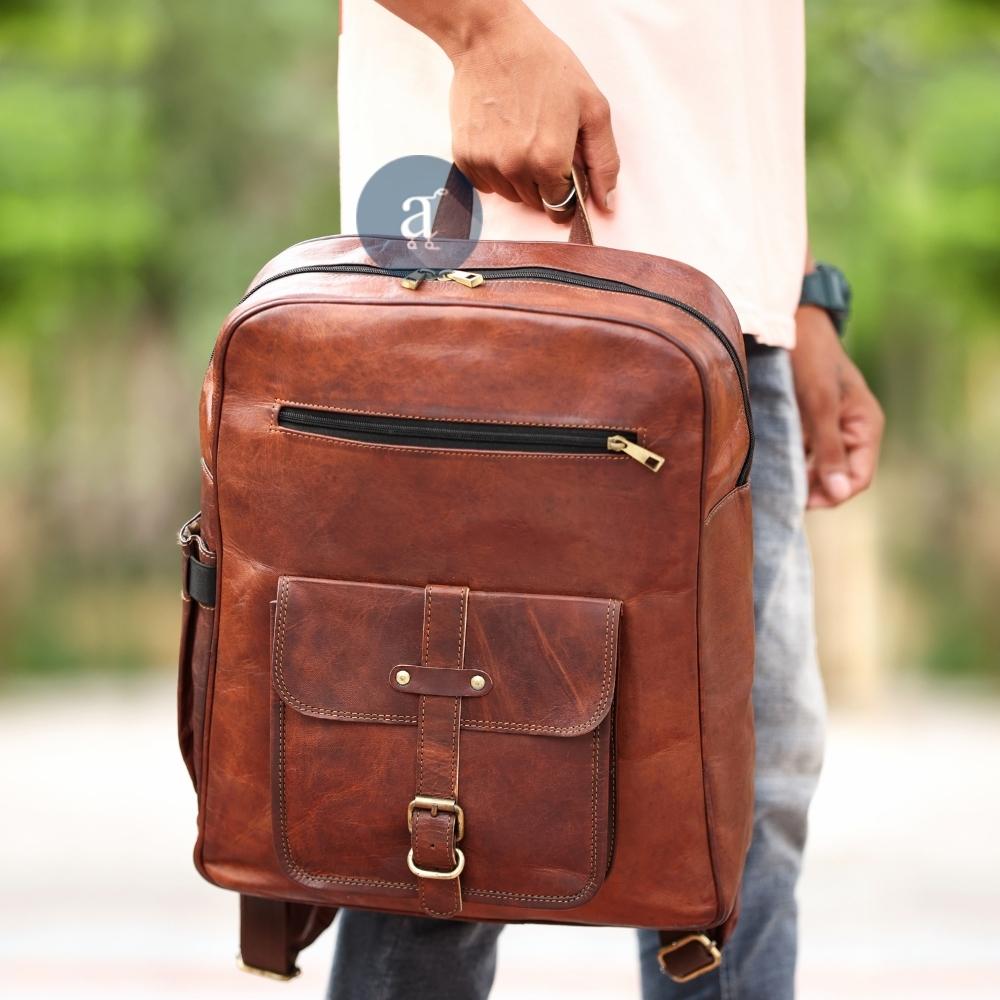 Men Carrying Leather Backpack with Top Handle
