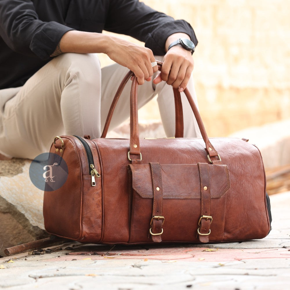 Men Sitting and Holding Leather Weekender Bag With Shoe Compartment from Top Handles