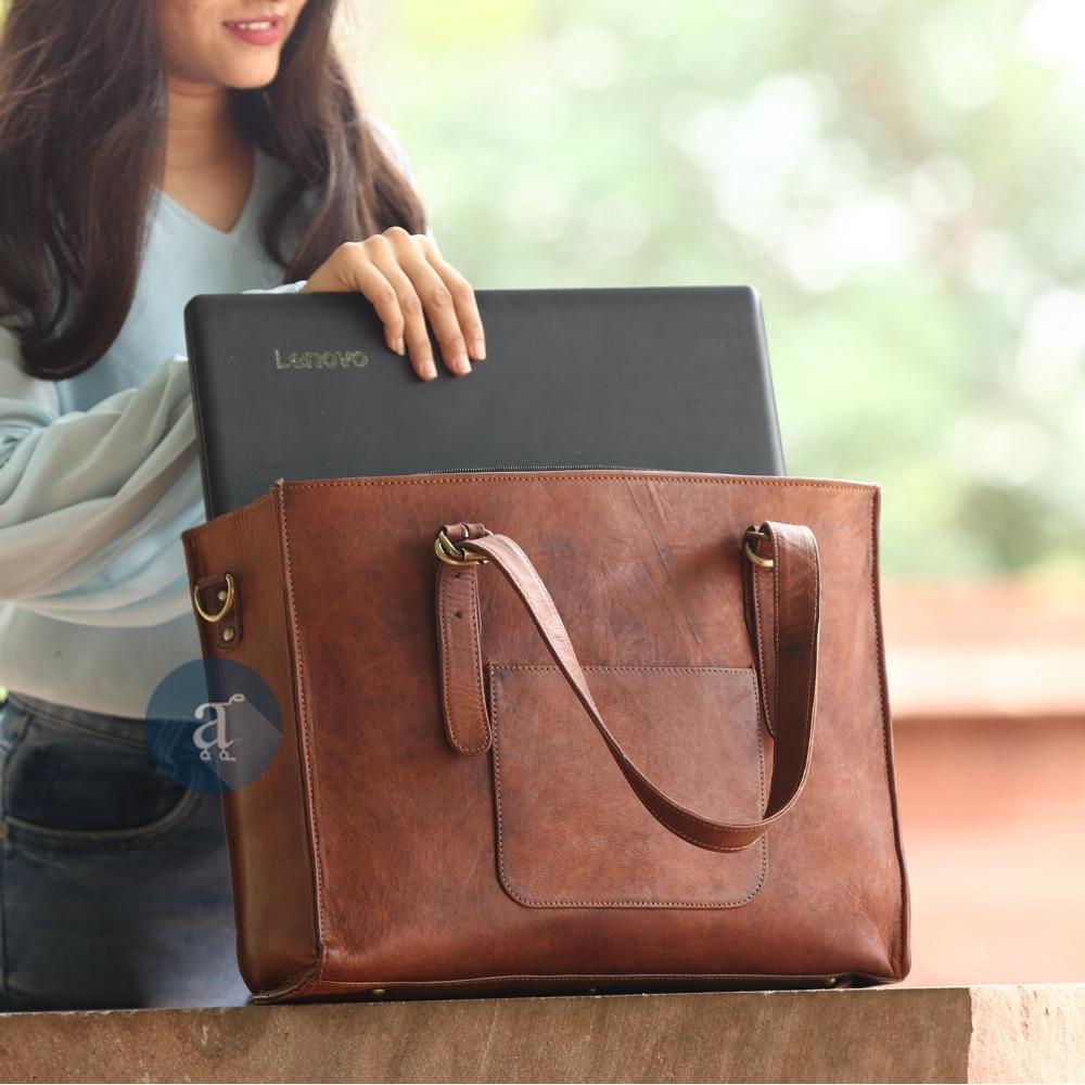 Woman Placing a Laptop into a Brown Leather Laptop Tote Bag