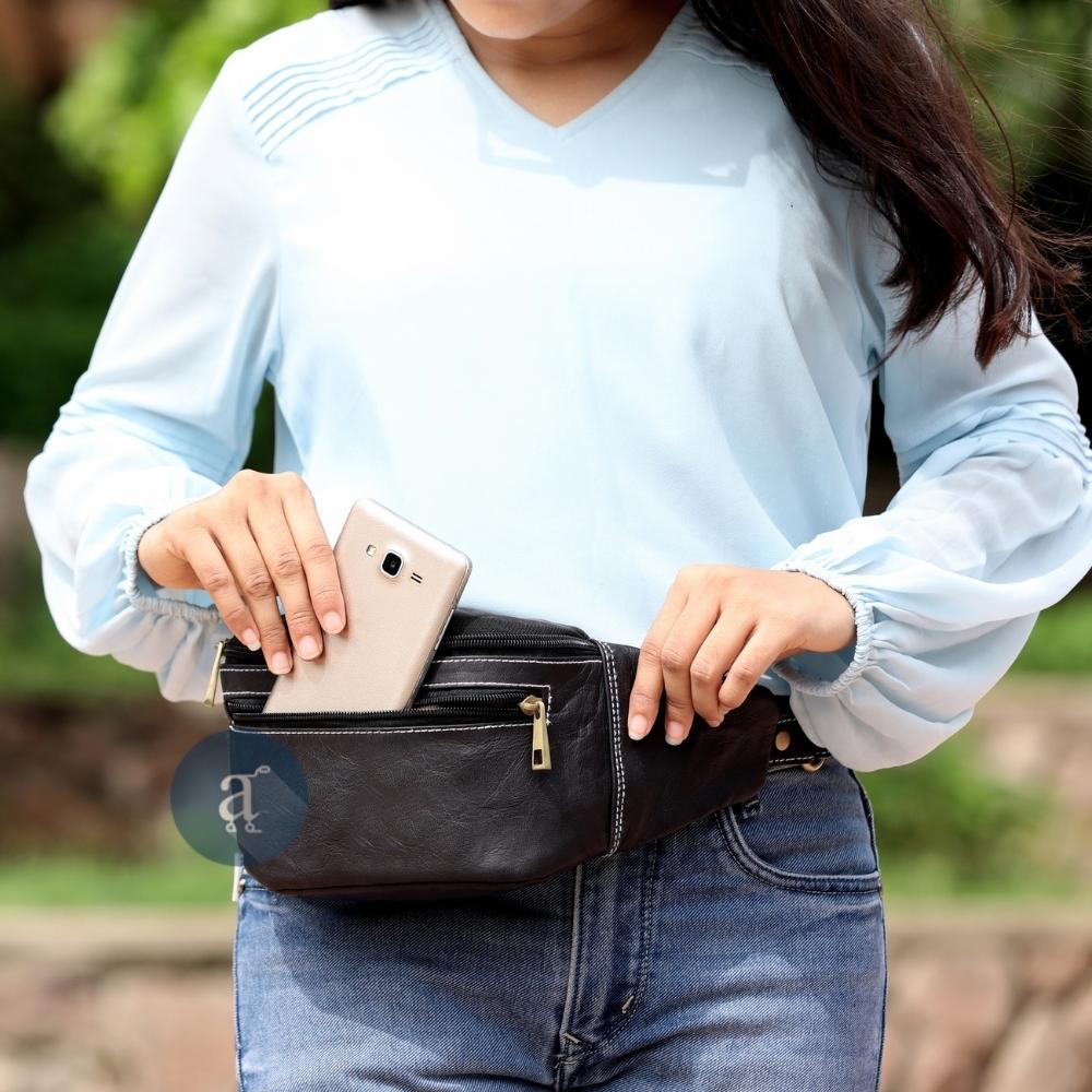 Women Putting Phone in Black Leather Fanny Pack