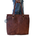 Women Carrying Brown Tote from Handles