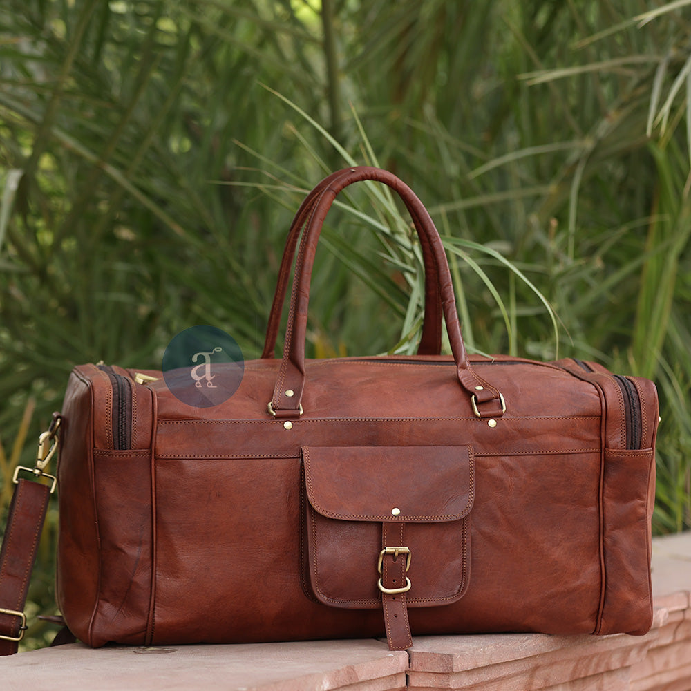 The Yachtsman Duffle Placed On A Stone Bench, With Green Foliage In The Background, Showing Its Elegant Design